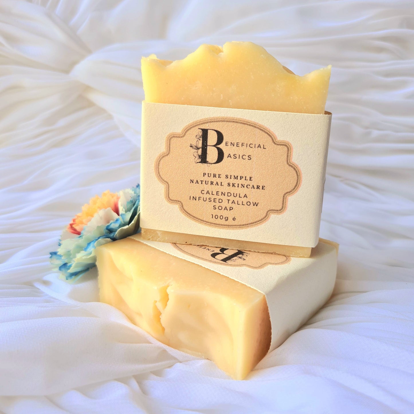 Bar of beef tallow calendula soap with a visible brand label on a textured white background
