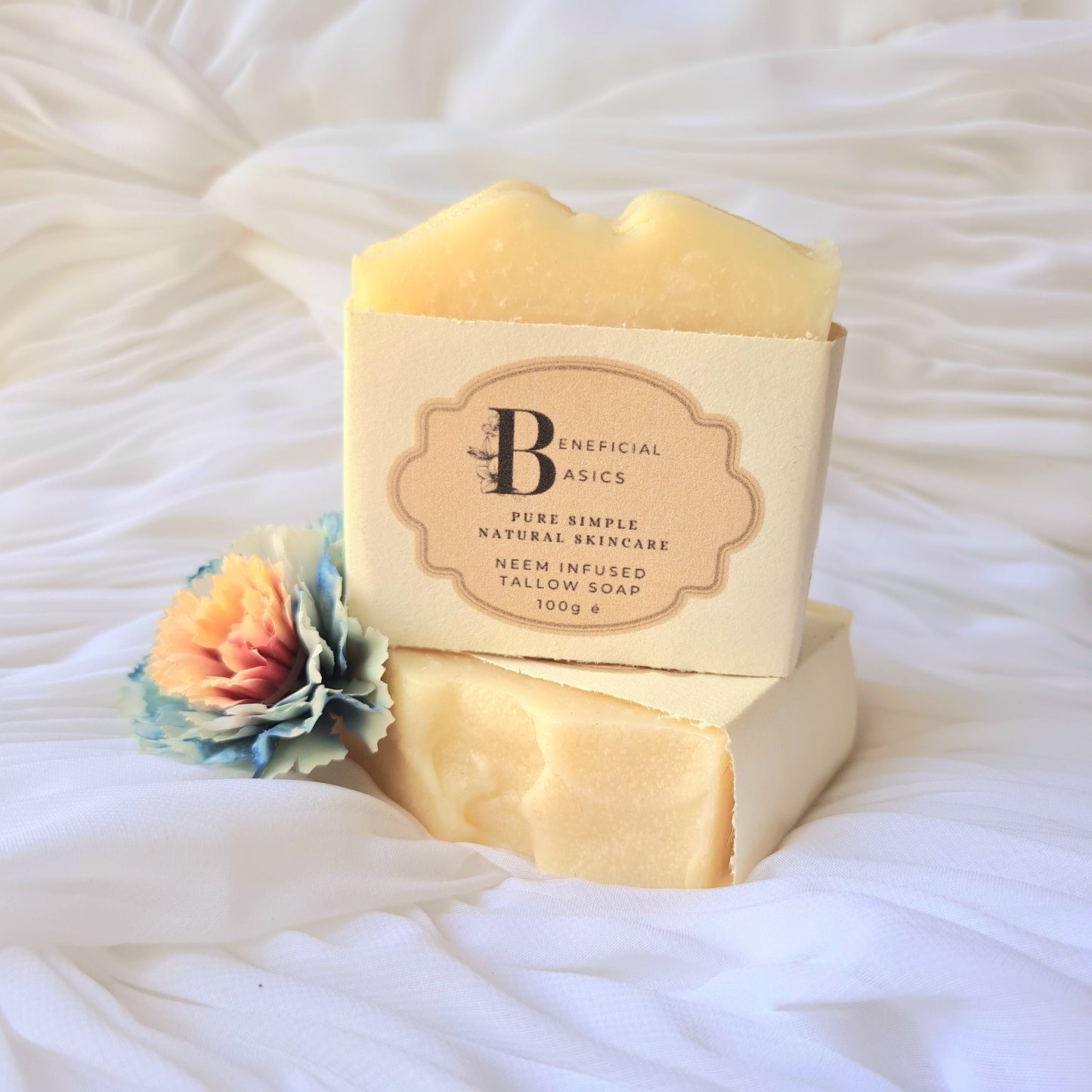 Two bars of neem soap with a visible brand label on a white textured surface.