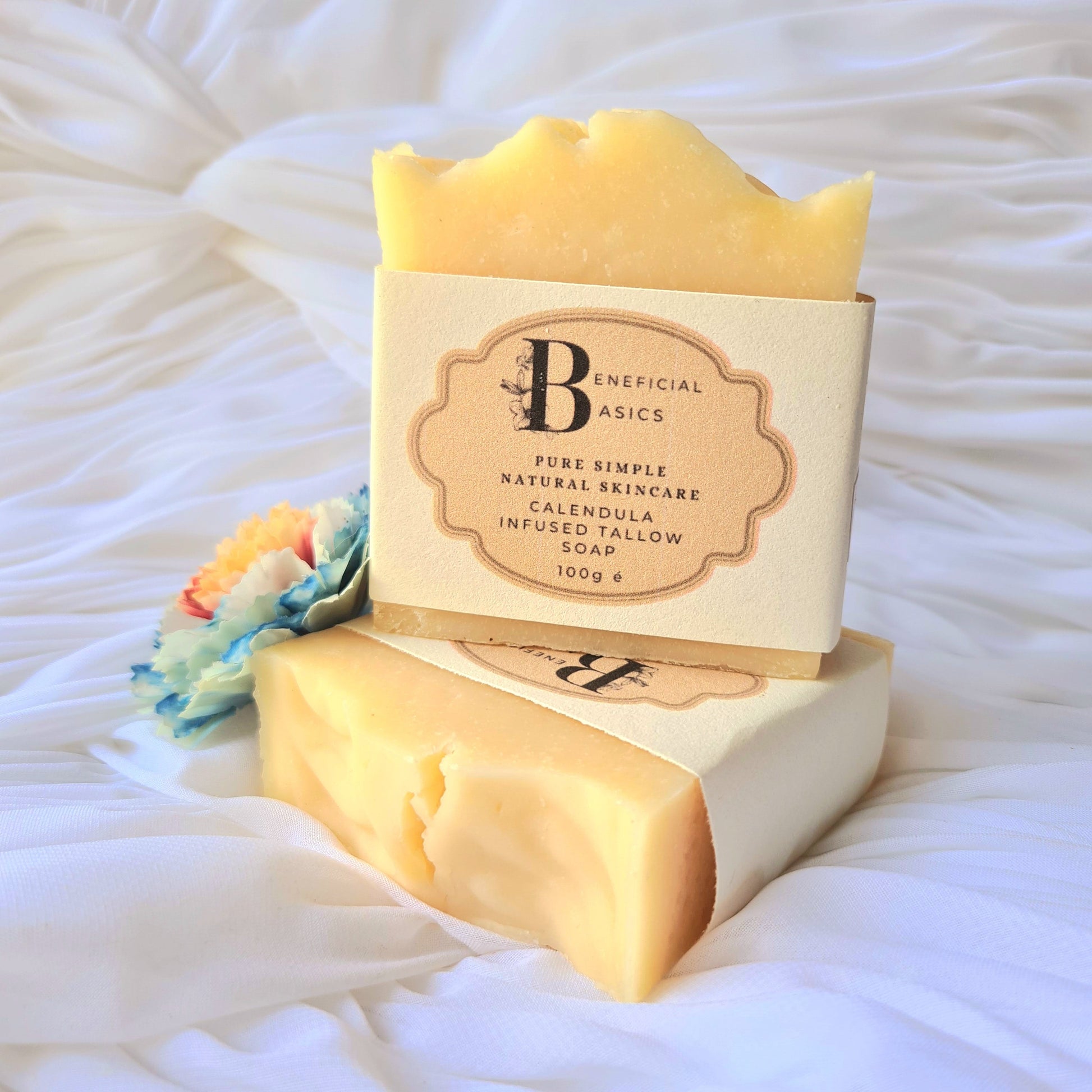 Bar of beef tallow calendula soap with a visible brand label on a textured white background