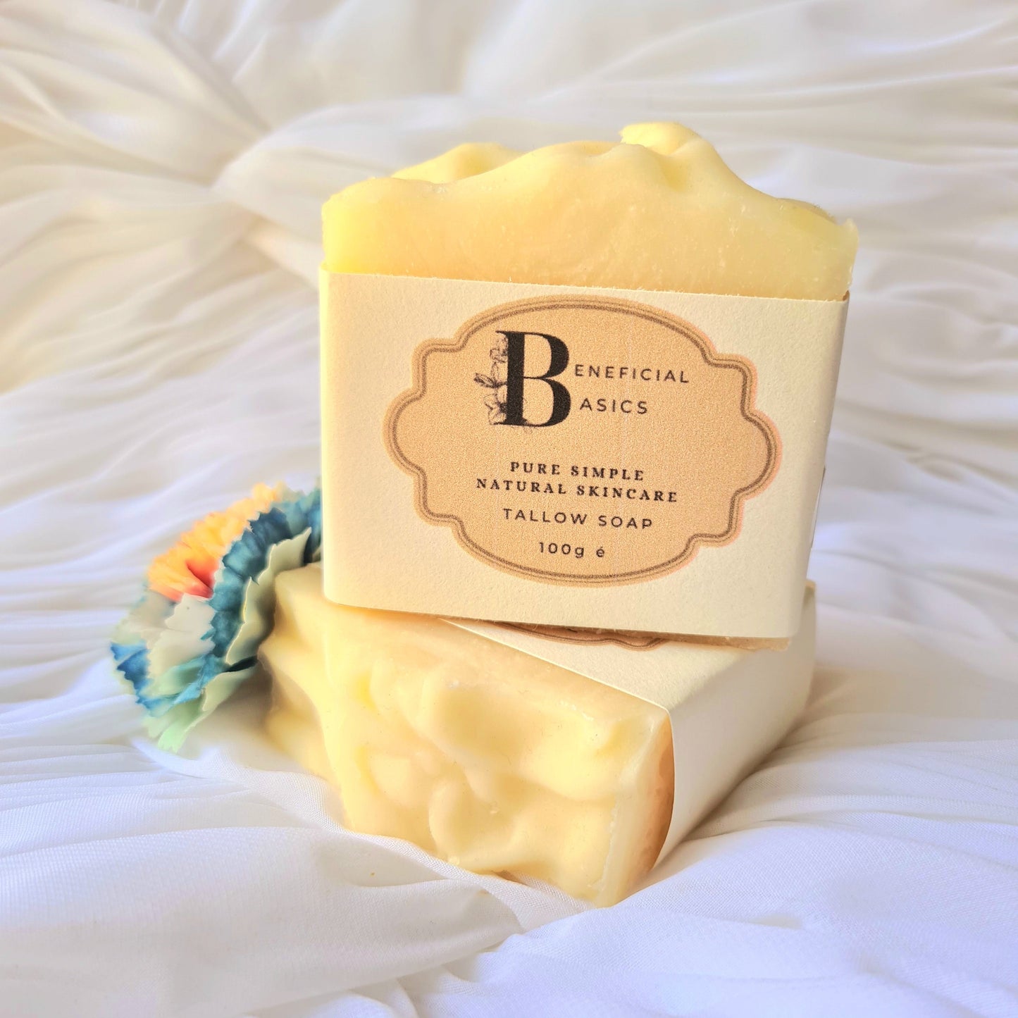Bar of beef tallow soap with a visible brand label on a white textured background